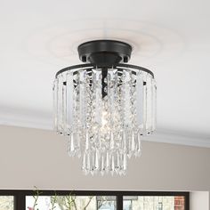 a chandelier hanging from the ceiling in a living room