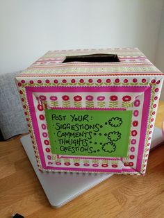 a pink and green box with writing on it