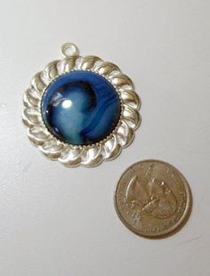 "Cloudy Blue onyx agate pendant bead in silver tone finding, natural stones,1 1/2\" diameter,This pendant could be wire wrapped or add charms Free shipping US A note about vintage, most items are used, and are 20, 30 or more years old. Occasionally, they can be found after being stored for many years, and are in pristine condition. Most have been gently used, and will show normal signs of use. All items are described as I accurately as can assess them. Pictures are the best description, and plea Silver Jewelry With Cabochon Round Beads, Blue Agate Round Jewelry, Nickel-free Agate Round Pendant Jewelry, Silver Agate Round Pendant Jewelry, Blue Agate Cabochon Jewelry, Blue Onyx, Gorgeous Glass, Kansas City Mo, Agate Pendant