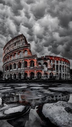 the colossion is surrounded by ice and snow as it stands in front of a cloudy sky