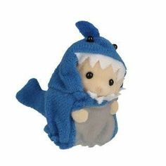 a stuffed animal that is wearing a blue and white outfit with a shark on it's back