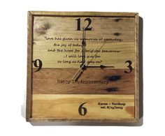 a wooden clock with the words happy 1st anniversary written on it