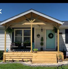 the front porch is covered with plants and flowers