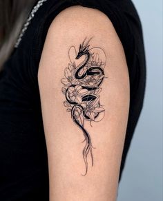 a woman's arm with a tattoo on it and a snake in the middle