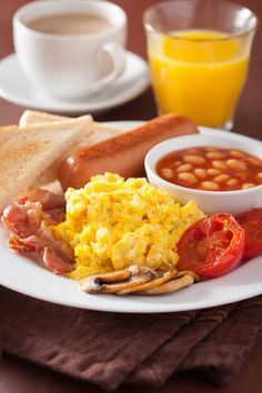 an english breakfast with eggs, toast, beans and tomatoes - stock photo - images