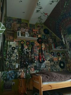 a bed sitting in a bedroom next to a wall covered with pictures and plants on it