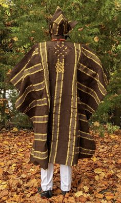 Esho African Aso Oke Grand boubou Agbada Robe - DP4085 Inner Dashiki Top and Pants sold separately Beaded Necklace and bracelet sold separately Abeti Aja Hat not included, sold separately Back of robe is mostly plain with some embroidery around the neckline. Handwoven, Silk and Cotton Blend Dry clean only Model is 6ft tall Traditional Brown Kaftan For Festive Occasions, Traditional Brown Festive Kaftan, Traditional Brown Kaftan For Festival, Beaded Necklace And Bracelet, Kente Cloth, Aso Oke, Turban Hat, Fashion Suits, Necklace And Bracelet