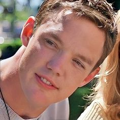 a young man and woman are smiling for the camera while wearing earbud's