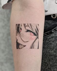 a woman's arm with an anime tattoo on it