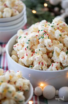 a bowl filled with white chocolate and sprinkles on top of a table