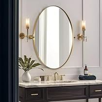 a bathroom with two sinks and a large round mirror