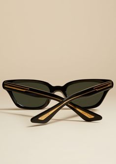 Description In collaboration with Oliver Peoples, the vision of KHAITE extends to eyewear. Handcrafted in Italy, these sunglasses offer decisive simplicity in a sleek silhouette defined by dramatic lines. Along the temples, a first-of-its-kind double embedding process exposes custom corewire inspired by the streamlined hardware of KHAITE handbags. Tipped with alternating logos, the temples also feature dual pins: functional elements that enhance the strength and flexibility of the frames. Each p Black Wayfarer Sunglasses For Formal Occasions, Vintage Black Sunglasses For Outdoor, Retro Black Sunglasses For Formal Occasions, Vintage Black Sunglasses With Mirrored Lenses, Retro Black Sunglasses For Outdoor, Luxury Black Sunglasses For Outdoor, Vintage Black Sunglasses With Tinted Lenses, Retro Black Sunglasses With Gradient Lenses, Black Retro Sunglasses With Gradient Lenses