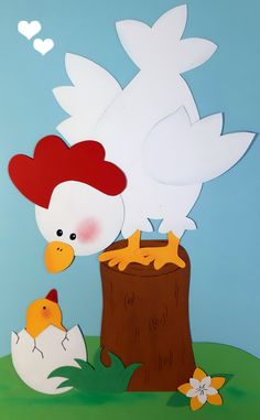 a paper cut out of a chicken and its chickling nest on a tree stump