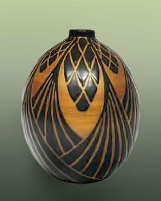 a black and yellow vase with lines on it