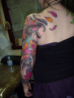 a woman with tattoos on her arm and shoulder