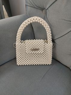 This mini pearl bead wedding bag is completely handmade. This and other pearl bags are all made of luxury plated pearl beads and will not fade or fray. This handmade pearl bead bag will be a good option to use at your weddings, engagements and special occasions. If you are looking for a different gift for your loved ones, this top handle bead bag is a good option for you. For longer use, protect the beaded bride purse from bumps, drops and direct sunlight.  Details: Completely handmade Luxury pl Bride Gift Bags, Bead Purse, Beads Bag, Luxury Plates, Bead Bag, Wedding Bags, Pearl Bag, Bride Gift, Wedding Bag