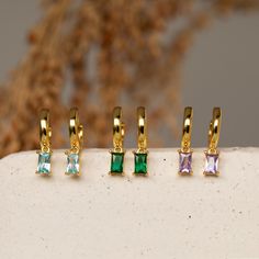 B A G U E T T E ∙ S T O N E ∙ H U G G I E S  Add color and sparkle into your jewelry collection with our baguette birthstone huggie earrings. These earrings are dainty with a tiny baguette charm in any month's birthstone. This is an easy gift for anyone who wants a little bit of personalization while still maintaining their subtlety. * Material: High Quality Solid 925 Sterling Silver  * Finish: 18K Gold  * Hoop Dimensions: ~7mm Inner Diameter | ~11mm Outer Diameter  * Featuring Birthstone Huggie Birthstone Earrings, Link Earrings, Huggie Hoop Earrings, Birthstone Necklace, Easy Gifts, Jewelry Earrings Hoops, Gold Hoop, Gifts For New Moms, Gold Hoop Earrings