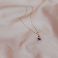 This super dainty evil eye charm necklace in gold filled is the perfect gift for your best friend, or better yet, yourself. This tiny evil eye pendant necklace is perfect for layering and the the shade of blue is really eye catching.   THE DETAILS: 🖤 14K Gold-filled or Sterling Silver Necklace  🖤 8mm Blue Evil Charm with Gold Filled or silver plated brass Trim 🖤 14, 15, 16, 18 or 20 inches length necklace(14 = small choker, 15 = regular choker, 16 = collarbone,  18 = standard, 20 = long) 🖤 L Dainty Evil Eye Charm Necklace Gift, Dainty Evil Eye Necklace For Gift, Dainty Evil Eye Necklace Gift, Dainty Sapphire Birthstone Necklace For Gift, Blue Dainty Birthstone Necklace For Gift, Dainty Blue Birthstone Necklace As Gift, Dainty Blue Birthstone Necklace For Gift, 14k Gold Sapphire Necklace Gift, Dainty Yellow Gold Evil Eye Charm Necklace