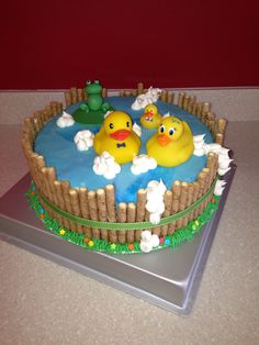 there is a cake with two rubber ducks in the water