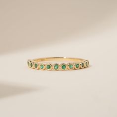 Arleth Timeless, elegant & dainty, this rich shade of green will make you feel like royalty each time you gaze at your hand! This can be your vibrant and unique wedding band, yet also the perfect dainty ring to add a pop of color to your solid gold ring stack. Emeralds fill ½ of the band. Choose your metal and size, and we will make it custom for you. May’s birthstone, this is a stunning ring to stack with your wife’s wedding ring! - Handmade- Solid Gold- Natural Emerald- Total Emerald Carat Wei Yellow Gold Stackable Emerald Birthstone Ring, 14k Gold Emerald-cut Stackable Rings For May Birthstone, Fine Jewelry Emerald Ring Stackable, Gift, Green Emerald-cut Stackable Birthstone Ring, Push Present Ring, Classic Green Gemstone Eternity Band, Push Present, Unique Wedding Band, Solid Gold Ring