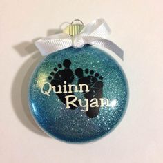 a blue ornament with an image of a baby's footprints on it