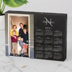 a family photo is displayed in a black box with the date and year printed on it