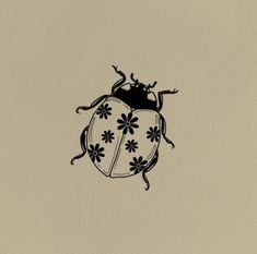 a black and white drawing of a ladybug with flowers on it's back