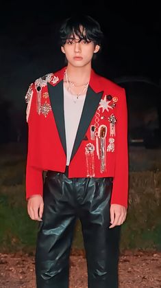 a man in a red jacket and black pants