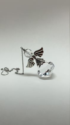 "2.5\" Angel prism, ornate with a clear large facets diamond shaped 30mm crystal, antique silver plated angel wing and a clear faceted 12mm crystal bead. 12\" long from hook to bottom. Hand made! All purchase will arrive in gift boxes. Thanks for stopping by!" Elegant Silver Crystals For Gift, Elegant Silver Crystals For Gifts, Elegant Silver Crystals As A Gift, Elegant Silver Faceted Crystals, Faceted Silver Crystal, Faceted Crystals As Gifts, Faceted Crystal Gift, Spiritual Silver Crystal, Winged Angel