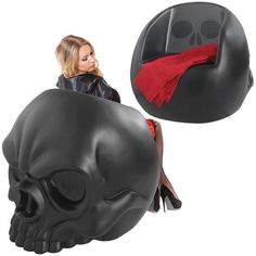 a woman sitting on top of a black skull shaped chair next to a red scarf