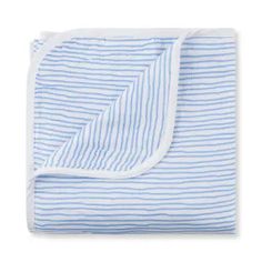 the blue and white striped blanket is folded on top of a white sheet with an open end