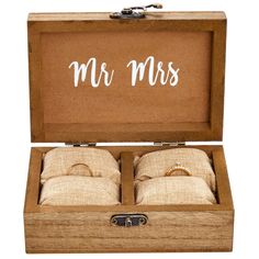 two wedding rings in a wooden box with mr and mrs written on the inside side