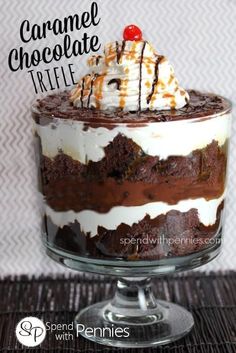 a chocolate trifle with whipped cream and caramel on top in a glass dish