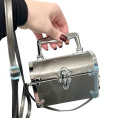 a person is holding onto a metal briefcase