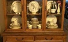 an old china cabinet with glass doors and plates on the front, before and after