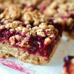 some food is sitting on top of a white plate with blueberries and oatmeal