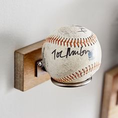 an old baseball is hanging on the wall