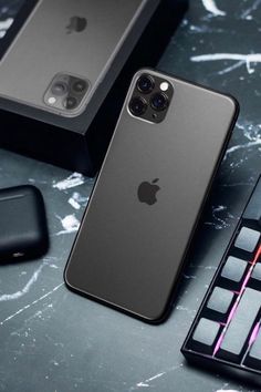 the new iphone 11 pro is on display next to its keyboard, mouse and other accessories