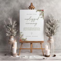 an easel with flowers and candles next to a sign that says,'welcome to our unplugged ceremony '