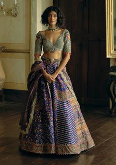 Indulge in timeless elegance with this classic kalidar lehenga set, crafted from rich purple jacquard silk banarasi. Featuring intricate floral embroidery enhanced with zari and zardozi work, the design is further adorned with dabka, sequins, pearls, and gota texturing. The ensemble includes a heavily embroidered blouse with a floral embroidery pattern, embellished with pearl tassels. Complemented by a shimmering purple tissue dupatta, adorned with floral embroidered botis and a scalloped embroi Aditi Gupta, Kalidar Lehenga, Embroidered Bridal Lehenga, Tassel Embroidery, Banarasi Lehenga, Floral Embroidery Patterns, Purple Silk, Bridal Lehenga, Embroidered Blouse