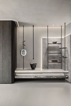 a modern bathroom with black and white accessories on the counter, along with shelving