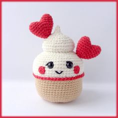 a crocheted cupcake with two hearts on it's head and eyes