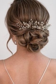 the back of a woman's head wearing a bridal hair piece