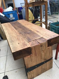 a wooden table sitting on top of a tiled floor