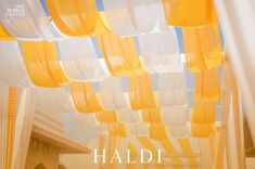 the cover of haldi magazine with yellow and white drapes hanging from it's ceiling