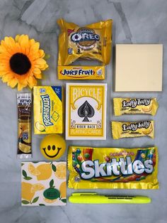 the contents of a candy bar laid out next to a sunflower and some pens