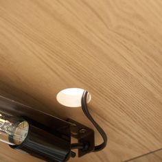 a light that is on the side of a wooden wall next to a lamp fixture