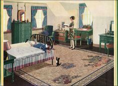 a woman standing next to a bed in a bedroom with a cat on the floor