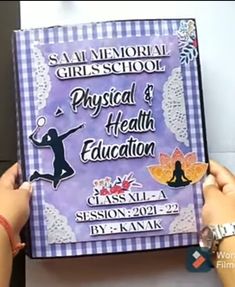 a person holding up a book with the words physical and health education written on it