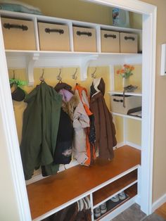 a coat rack filled with coats and shoes in a home entryway or sitting area